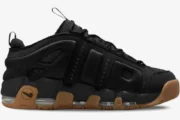 Nike Air More Uptempo Low in black with a gum sole, shown from a side profile view. - SKU FZ3055003