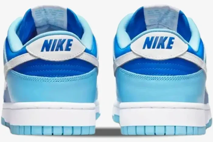 Rear view of Nike Dunk Low Argon sneakers in light and dark blue with white heel tabs and blue Nike logo. - SKU DM0121-400