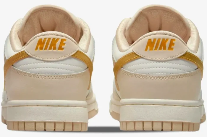 Rear view of women's Nike Dunk Low Essential Trend in Phantom with metallic gold heel branding. - SKU DX5930-001