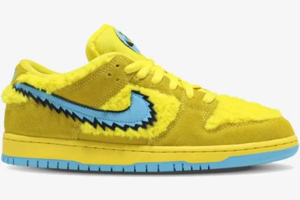 Nike SB Dunk Low Grateful Dead Bears Opti Yellow fuzzy sneaker with blue jagged swoosh, side profile view. - SKU CJ5378-700