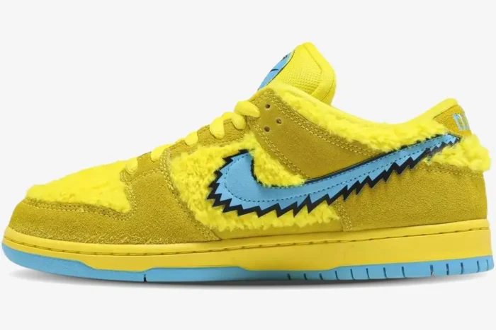 Side profile of Nike SB Dunk Low Grateful Dead Bears in Opti Yellow featuring faux fur and a blue jagged swoosh. - SKU CJ5378-700