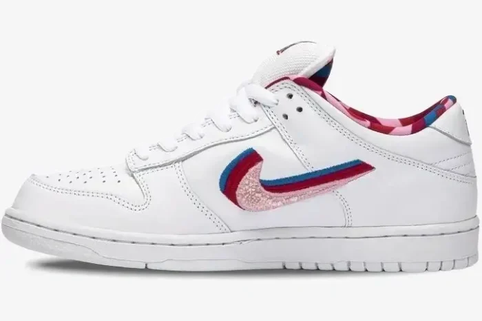 Nike SB Dunk Low x Parra in white with a multi-colored layered Swoosh, side profile view. - SKU CN4504-100