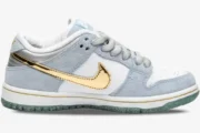 Side view of Nike SB Dunk Low Sean Cliver in light blue and white with a metallic gold swoosh. - SKU DC9936-100