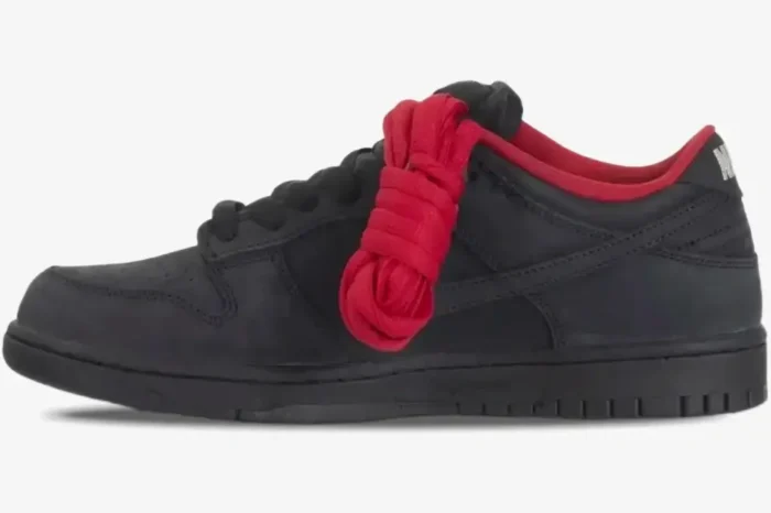 Side view of Nike SB Dunk Low 94 x Supreme in black with red lining and extra red laces. - SKU HQ8487001