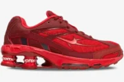Side profile of Nike Shox Ride 2 x Supreme sneakers in red with mesh upper and branded Shox columns. - SKU DN1615-600