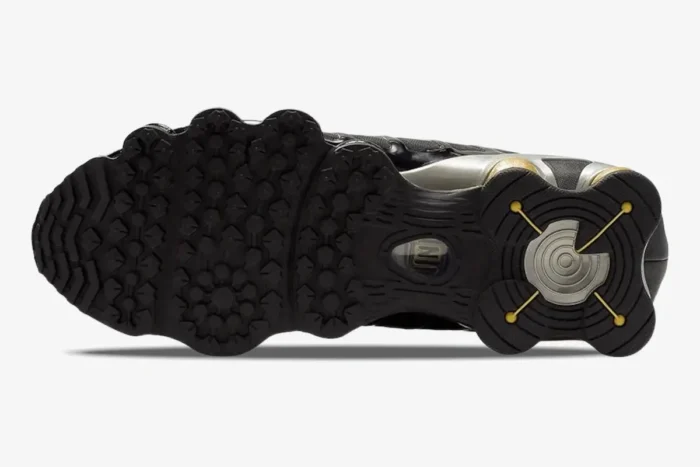 Bottom view of the Nike Shox TL x Neymar Jr. Black Gold sneaker outsole with textured grip and gold accents. - SKU BV1388-001