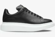 Alexander McQueen Oversized Sneaker in black leather with a thick white sole, side profile view. - SKU 553680WHGP51000