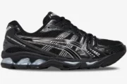 Side view of Asics Gel-Kayano 14 running shoes in black and metallic silver with mesh upper. - SKU 1201A019-006