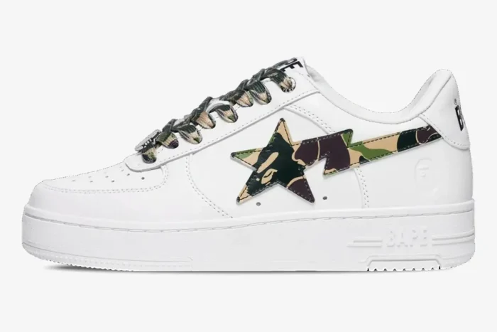 White Bape Sta Low sneaker with green ABC Camo star logo and laces, side profile view. - SKU 1K70191335-GRN