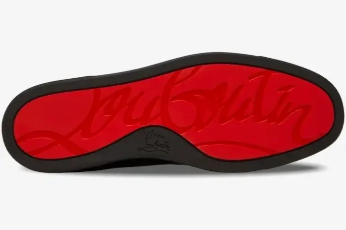 Bottom view of Christian Louboutin Louis Junior Spikes Flat 'Taupe' showing the signature red rubber sole. - SKU 1130575