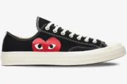 Side profile of a black Converse Chuck 70 low-top sneaker featuring the red CDG Play heart logo. - SKU 150206C