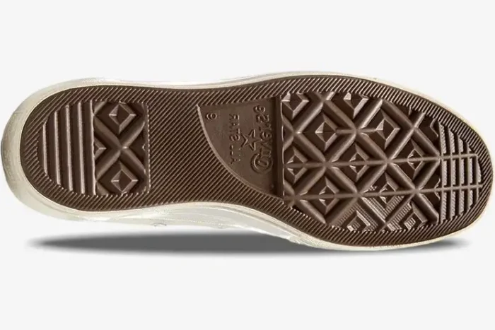 Bottom view of the brown rubber outsole on a Converse Chuck 70 x CDG Play white sneaker. - SKU A08805C
