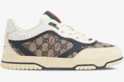 Side profile of a Gucci Re-Web sneaker in beige GG canvas with ivory and blue leather accents. - SKU 787476AADHW9552