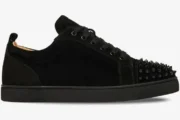 Side profile of a black suede Christian Louboutin Louis Junior Spikes Flat sneaker with spiked toe. - SKU 1130575