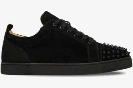 Side profile of a black suede Christian Louboutin Louis Junior Spikes Flat sneaker with spiked toe. - SKU 1130575
