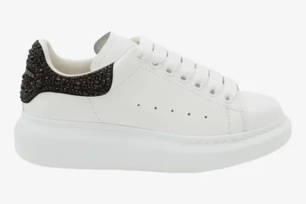 Alexander McQueen Oversized Sneaker in white with black crystal heel, side profile view. - SKU 666407WIAIJ9581