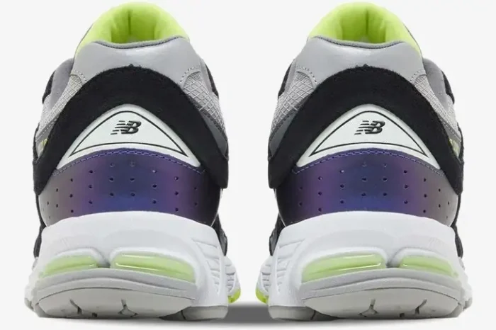 Rear view of New Balance 2002R x DTLR Purple Noir sneakers showing iridescent purple heels and lime green accents. - SKU M2002RHI