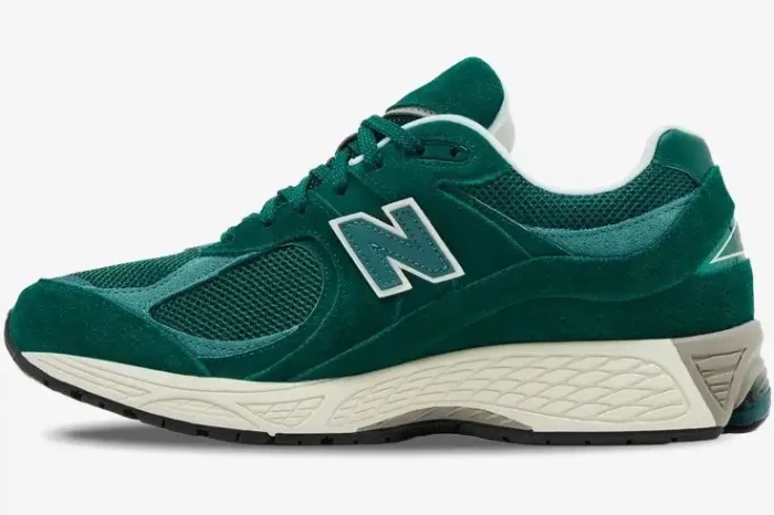 Side profile of a New Balance 2002R sneaker in dark green suede and mesh with a white midsole. - SKU M2002RG