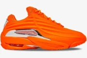 Nike Hot Step 2 x NOCTA sneakers in vibrant orange, shown from a side profile view with chrome accents. - SKU DZ7293-800