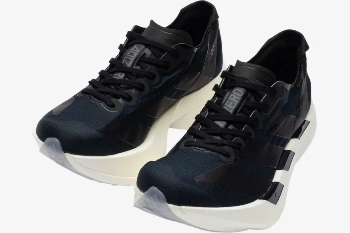 Adidas Adizero Adios Pro 4 running shoes in black and white, shown from a three-quarter front angle. - SKU JR6369