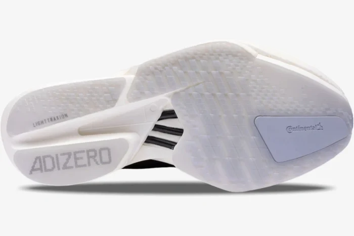 Bottom outsole view of Adidas Adizero Adios Pro 4 running shoe in black and white. - SKU JR6369