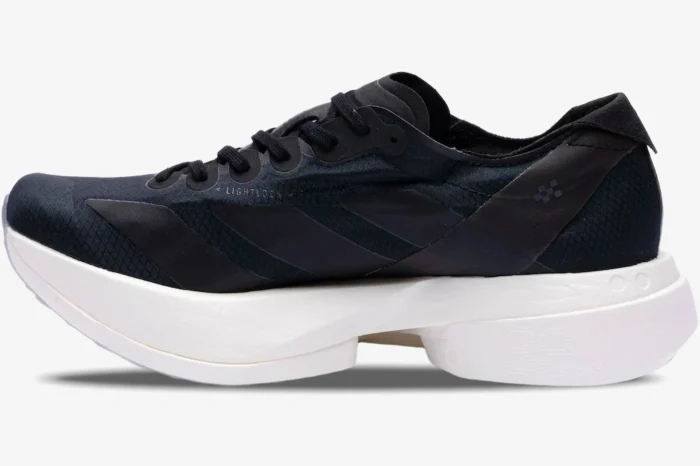 Side profile of the Adidas Adizero Adios Pro 4 running shoe in black and white with a thick midsole. - SKU JR6369