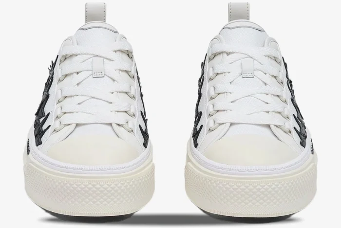 Front view of Amiri Stars Court low-top sneakers in white and black with star details. - SKU AMFOSR1179-111
