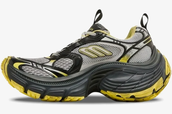 Side profile of a Balenciaga 10XL Sneaker in grey and yellow distressed mesh with an oversized chunky sole. - SKU 792779w2mv21097