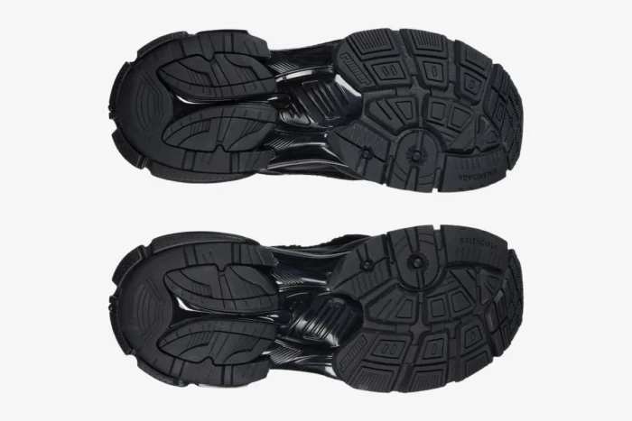 Bottom view of the textured black rubber outsoles on Balenciaga Runner all black distressed sneakers. - SKU 772774W3RBT1000