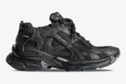Side profile of a Balenciaga Runner All Black Distressed Sneaker with mesh panels and chunky sole. - SKU 772774W3RBT1000