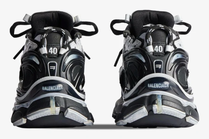Rear view of Balenciaga Runner Sneaker Distressed Edition in black and white showing heel branding. - SKU 772774W3RMU9010