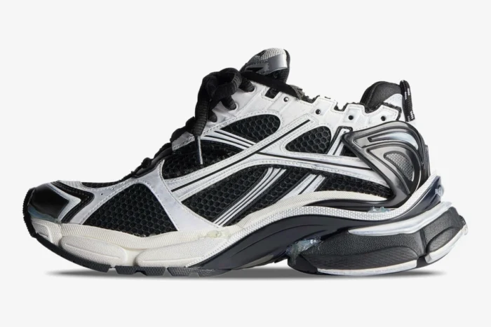 Side profile of Balenciaga Runner Sneaker Distressed Edition in black and white mesh with worn details. - SKU 772774W3RMU9010