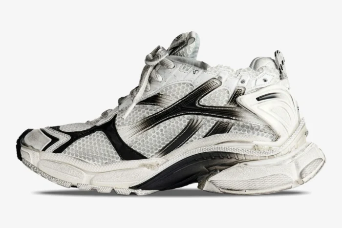 Side profile of white and black Balenciaga Runner Gradient Sneaker with a distressed, worn-out aesthetic. - SKU 677403W3RB19010