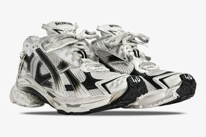 Three-quarter view of Balenciaga Runner Gradient sneakers in white and black with a distressed, worn-in look. - SKU 677403W3RB19010