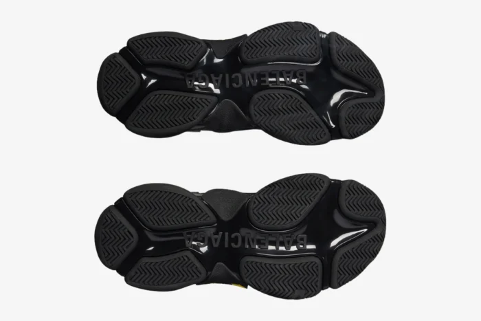 Bottom view of black and yellow Balenciaga Triple S Tapa Type sneakers showing the chunky outsole. - SKU 536737WTRST1070