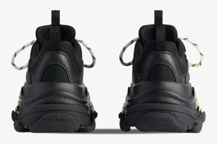 Rear view of Balenciaga Triple S Tapa Type sneakers in black with yellow accents. - SKU 536737WTRST1070