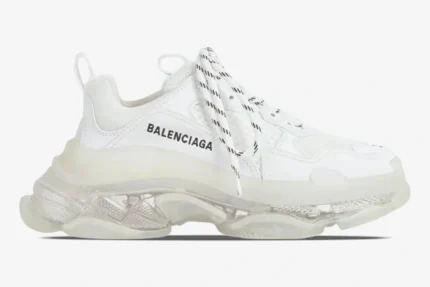 Side profile of a white Balenciaga Triple S sneaker with a chunky clear sole and black logo. - SKU 544351W2FB19000