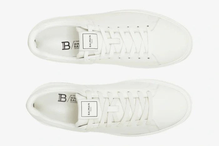 Top-down view of white Balmain B-Court calfskin trainers with white laces and logo details. - SKU GM1VI288LVTR
