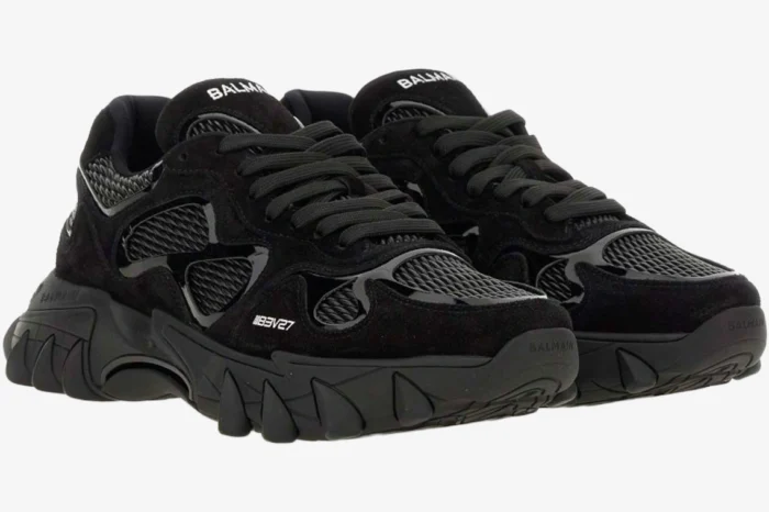 A pair of black Balmain B-East Low Top sneakers shown from a three-quarter front perspective. - SKU AM1VI327THPC-0PA