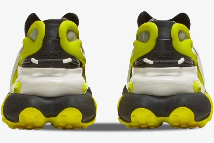 Back view of Balmain Unicorn low-top sneakers in black and neon yellow with chunky soles. - SKU YM0VJ309KNET