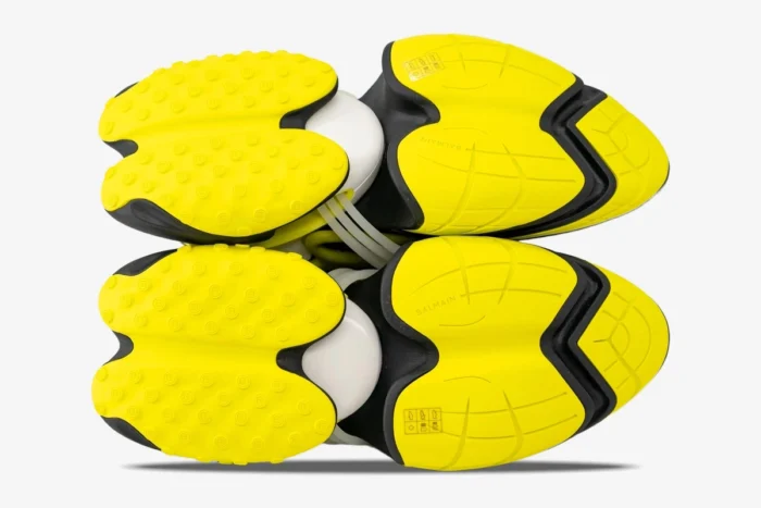Bottom view of Balmain Unicorn Low-Top sneakers in black and yellow showing the unique tread pattern. - SKU YM0VJ309KNET