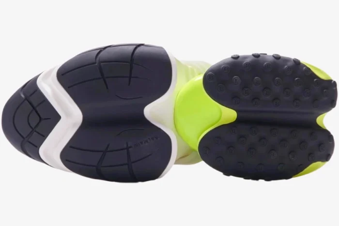 Bottom view of Balmain Unicorn sneakers in white and neon yellow showing the black segmented outsole. - SKU AM0VI294LNSB