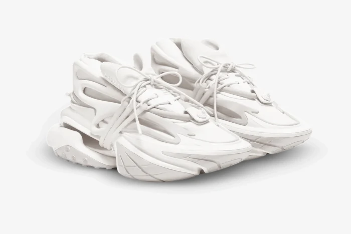 Balmain Unicorn Low-top white neoprene and leather sneakers in a three-quarter front view. - SKU AM0VJ309KNLR