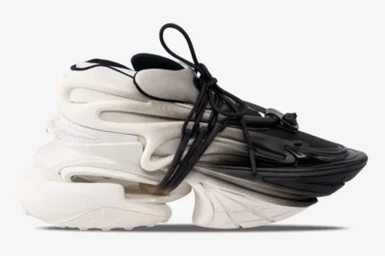 Side view of Balmain Unicorn low-top sneakers with a white and black gradient design and chunky sole. - SKU YM0VJ309KNED-GAB