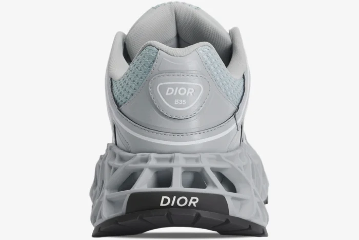 Rear view of a grey Christian Dior B35 NXXT sneaker featuring a lattice midsole and logo branding. - SKU 3SN323ZCY_H860