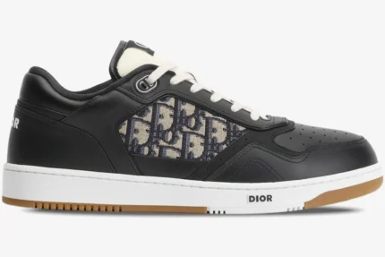 Dior B27 low-top sneaker in black leather with beige oblique motif, shown from a side profile view. - SKU 3SN272ZIR_H965