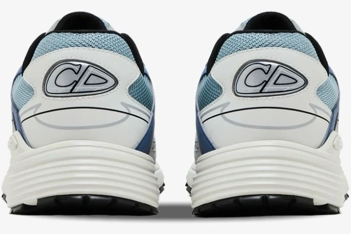 Rear view of Dior B30 sneakers in light blue, white, and grey featuring the CD logo on the heel. - SKU 3SN279ZRB_H560