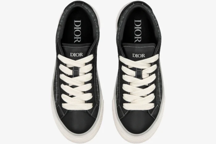 Top-down view of black Dior B33 Spin sneakers with white laces and Oblique jacquard details. - SKU 3SN303ZYS_H981