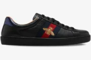 Side view of Gucci Ace Bee black leather sneakers with gold bee embroidery and web stripe. - SKU 42944602JP01284