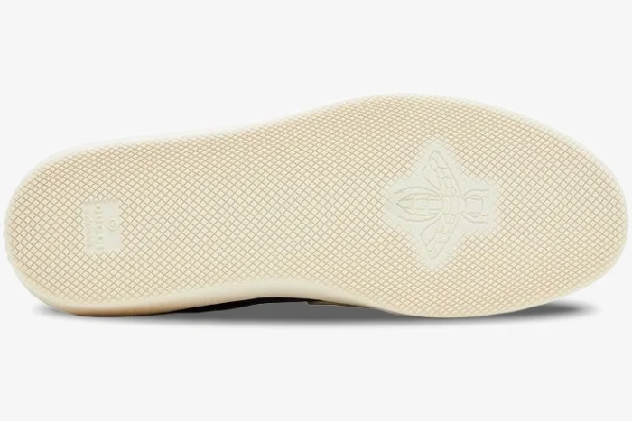 Bottom view of the Gucci G74 blue suede sneaker showing the cream rubber sole with bee logo. - SKU 791742AADM04141